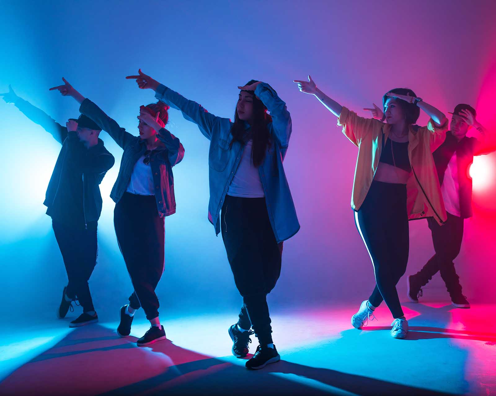 group dancing together with colorful stage lights