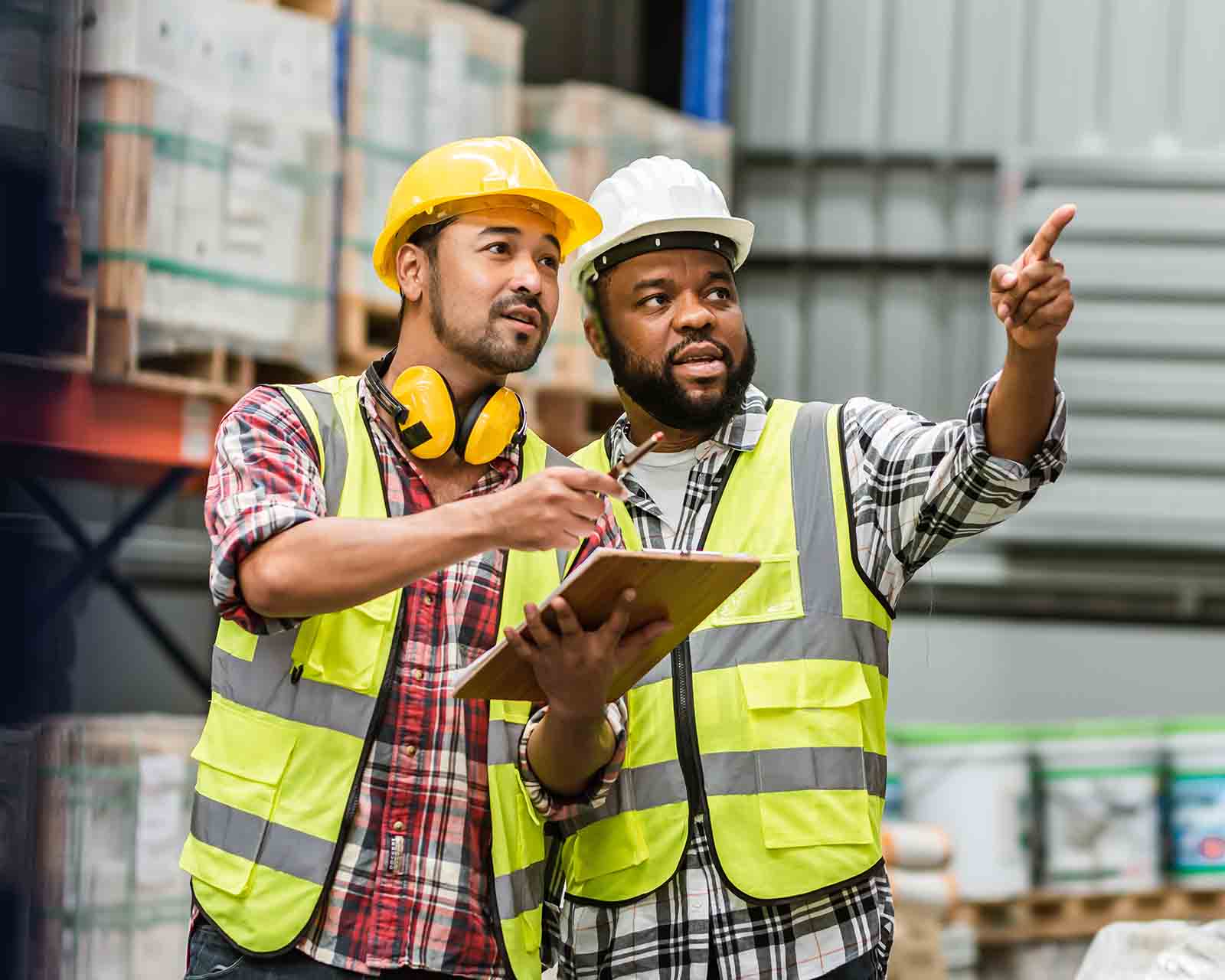 two site supervisors discussion policy while holding a clipboard