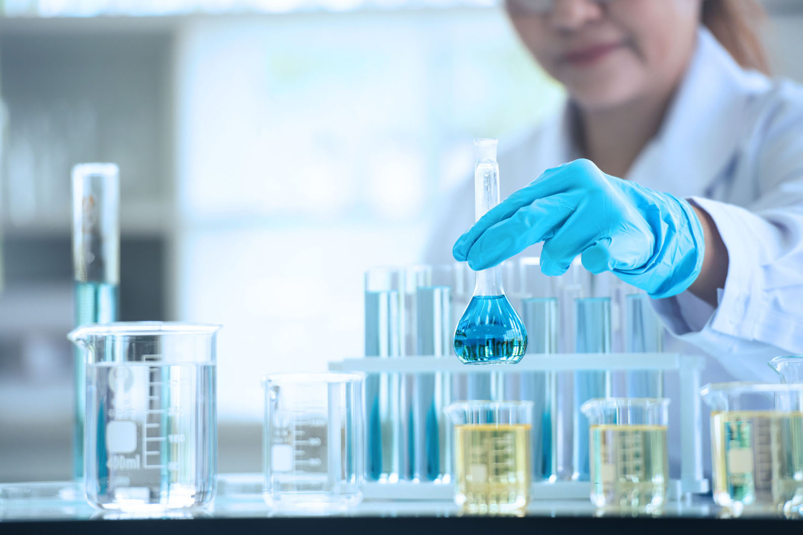 lab tech working with test tubes with liquid in them