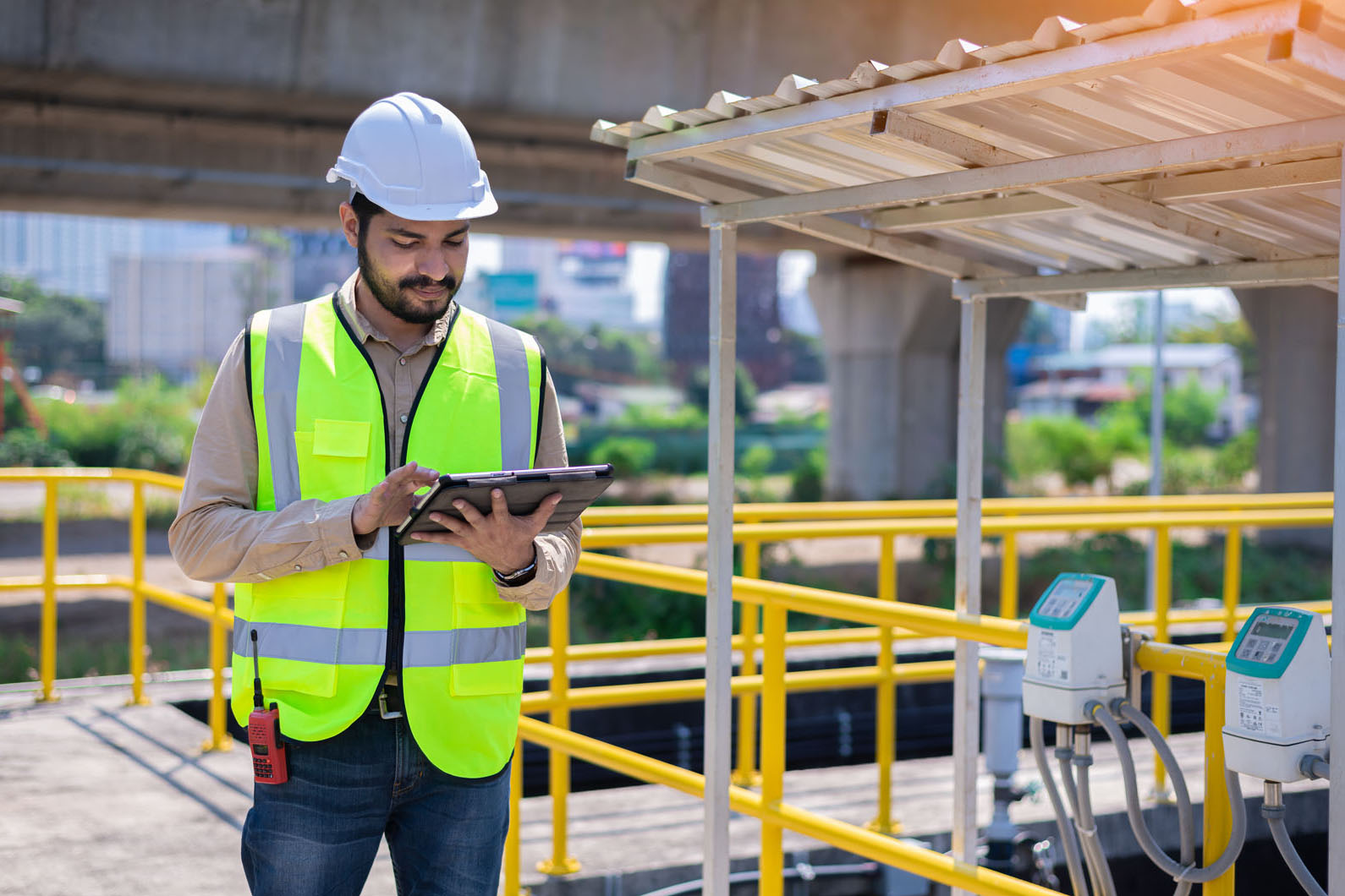 project manager checking a tablet at a work site